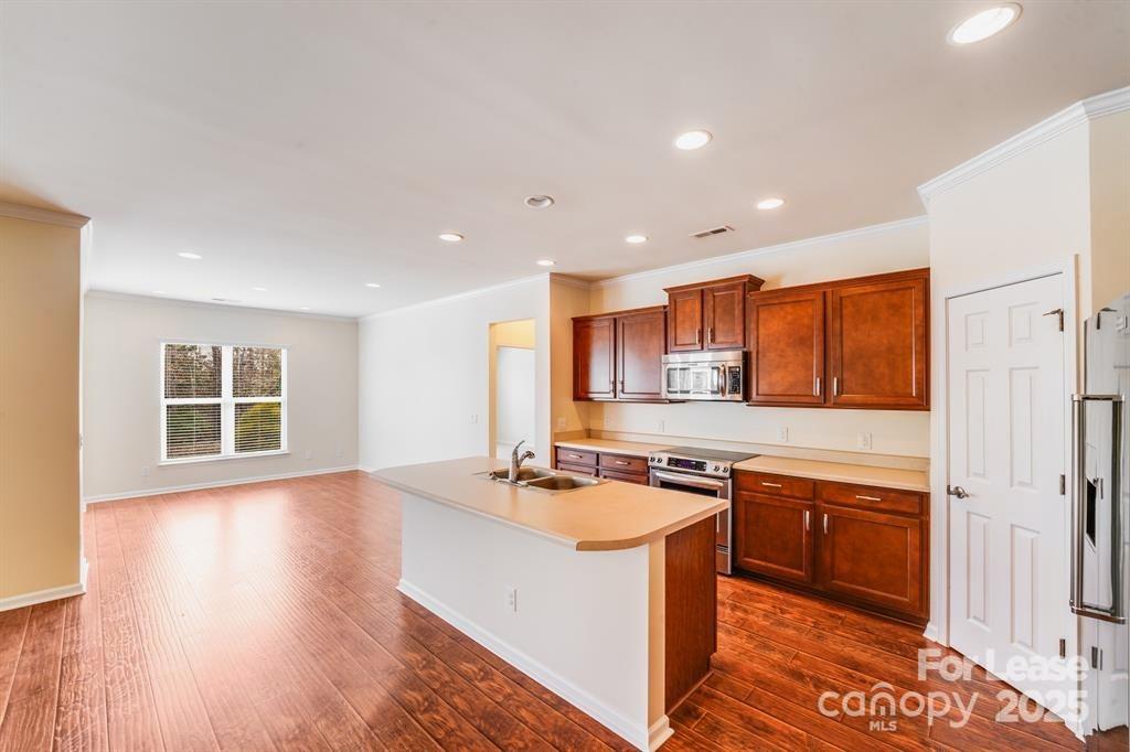7012 Kitty Hawk Lane Fort Mill, SC 29707 - Photo 11 of 46 a kitchen with stainless steel appliances granite countertop a sink stove and refrigerator
