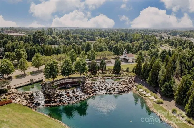 a view of a living room with furniture and a ceiling fan