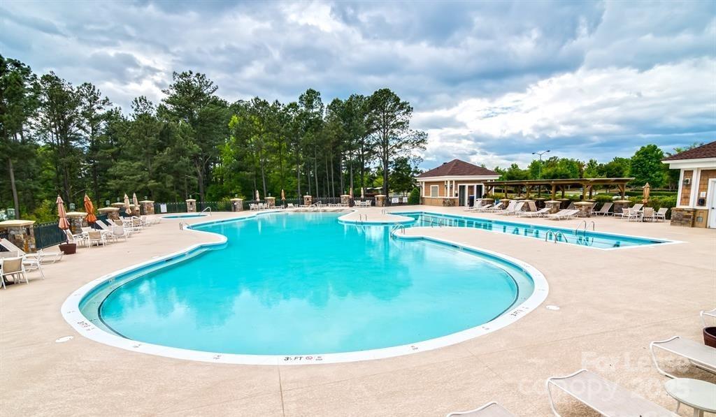 7012 Kitty Hawk Lane Fort Mill, SC 29707 - Photo 28 of 46 a view of a swimming pool with a garden