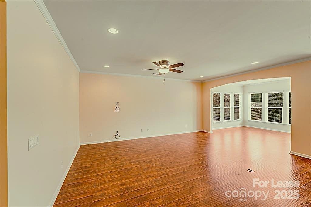 7012 Kitty Hawk Lane Fort Mill, SC 29707 - Photo 38 of 46 a view of an empty room with wooden floor and a window