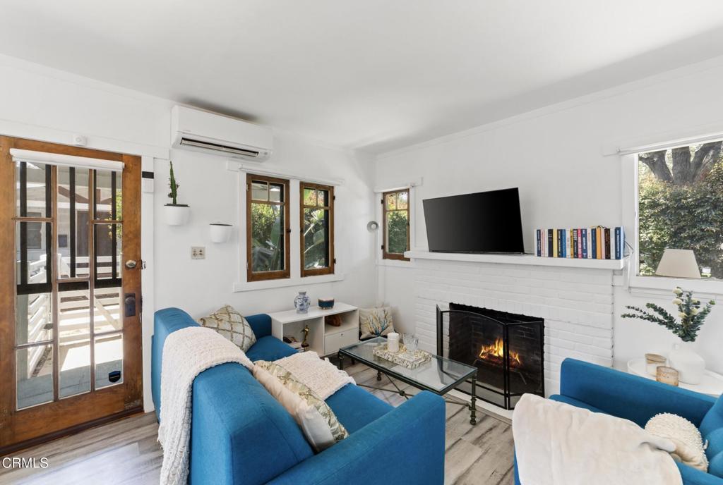 a living room with furniture fireplace and flat screen tv