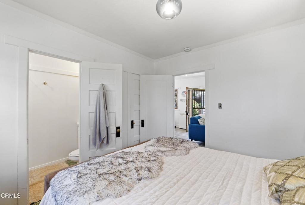 100 Palmetto Drive, Unit 2 Pasadena, CA 91105 - Photo 13 of 21 a bedroom with a large bed and a chandelier