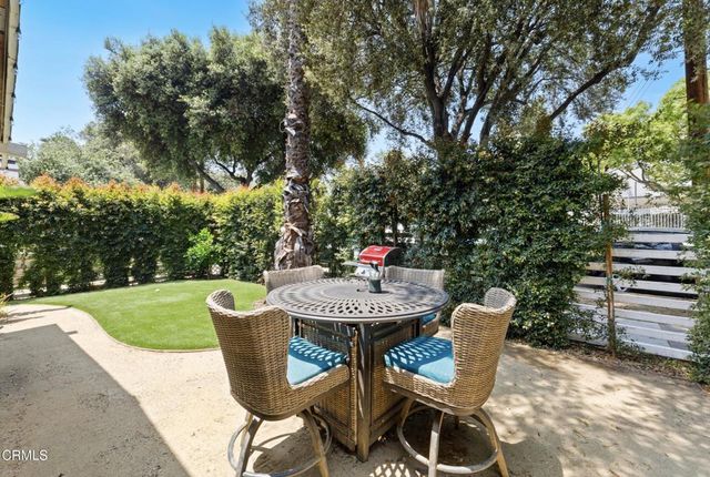 a view of a table and chairs in the garden