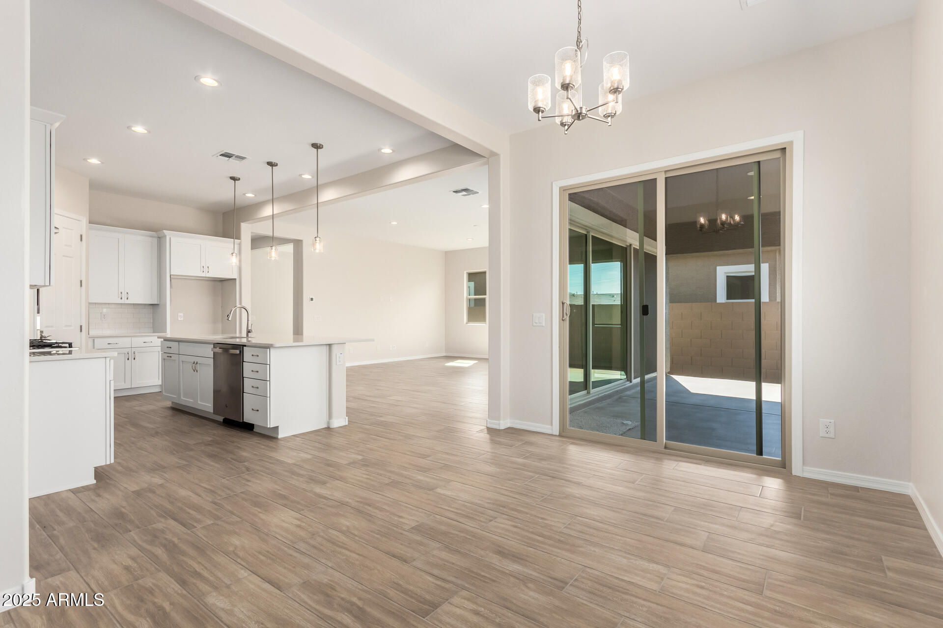 4818 West Capistrano Avenue Laveen, AZ 85339 - Photo 10 of 44 a view of a kitchen with refrigerator and wooden floor
