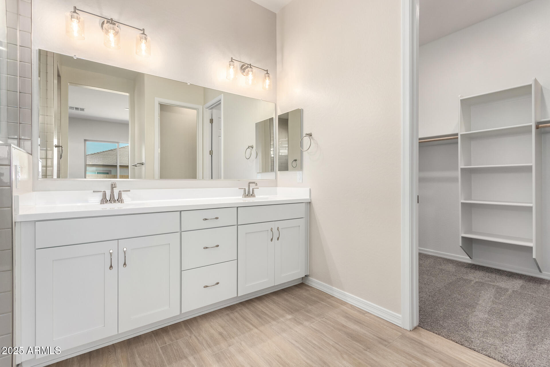 4818 West Capistrano Avenue Laveen, AZ 85339 - Photo 17 of 44 a spacious bathroom with double sink and a large mirror