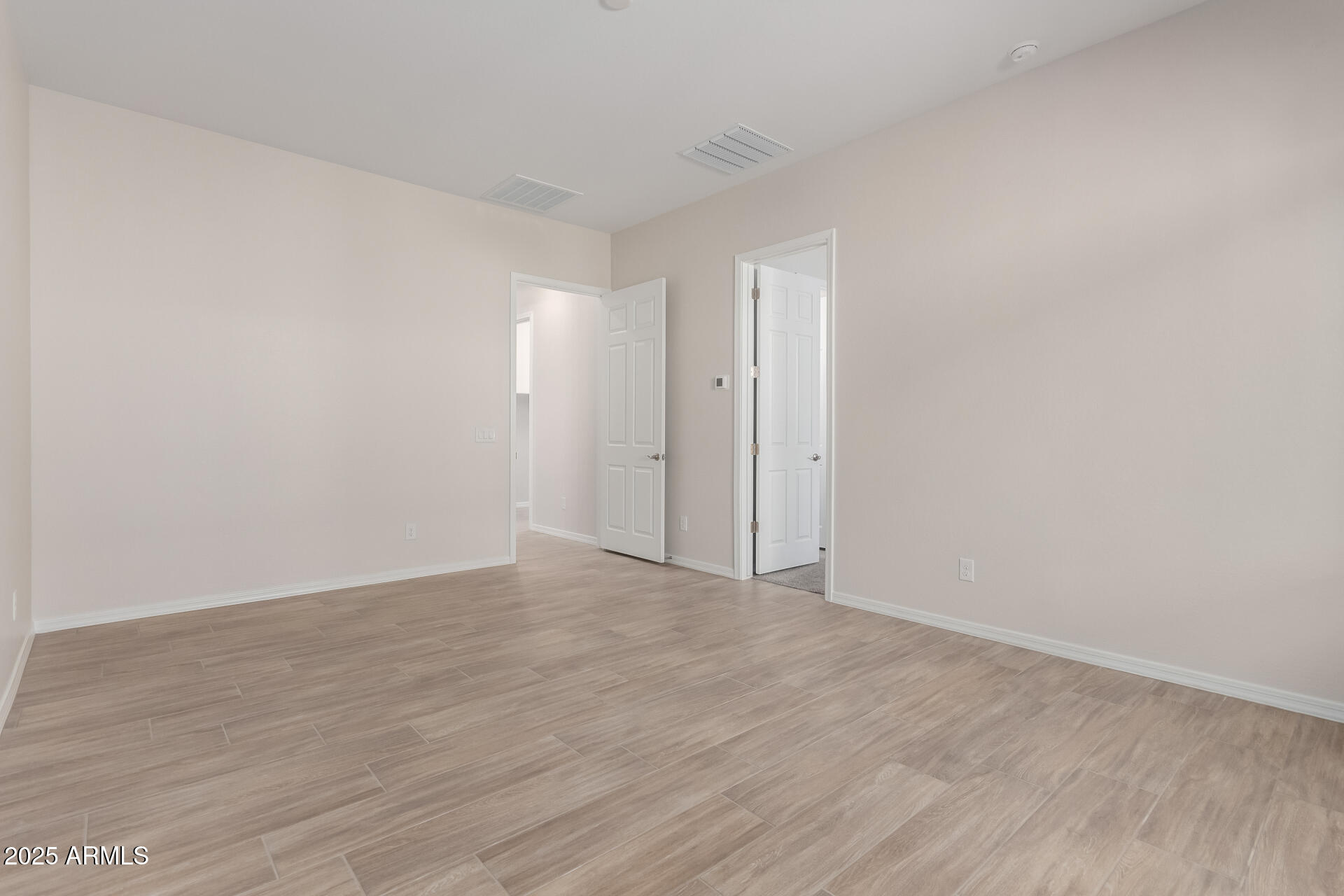 4818 West Capistrano Avenue Laveen, AZ 85339 - Photo 22 of 44 a view of an empty room and wooden floor