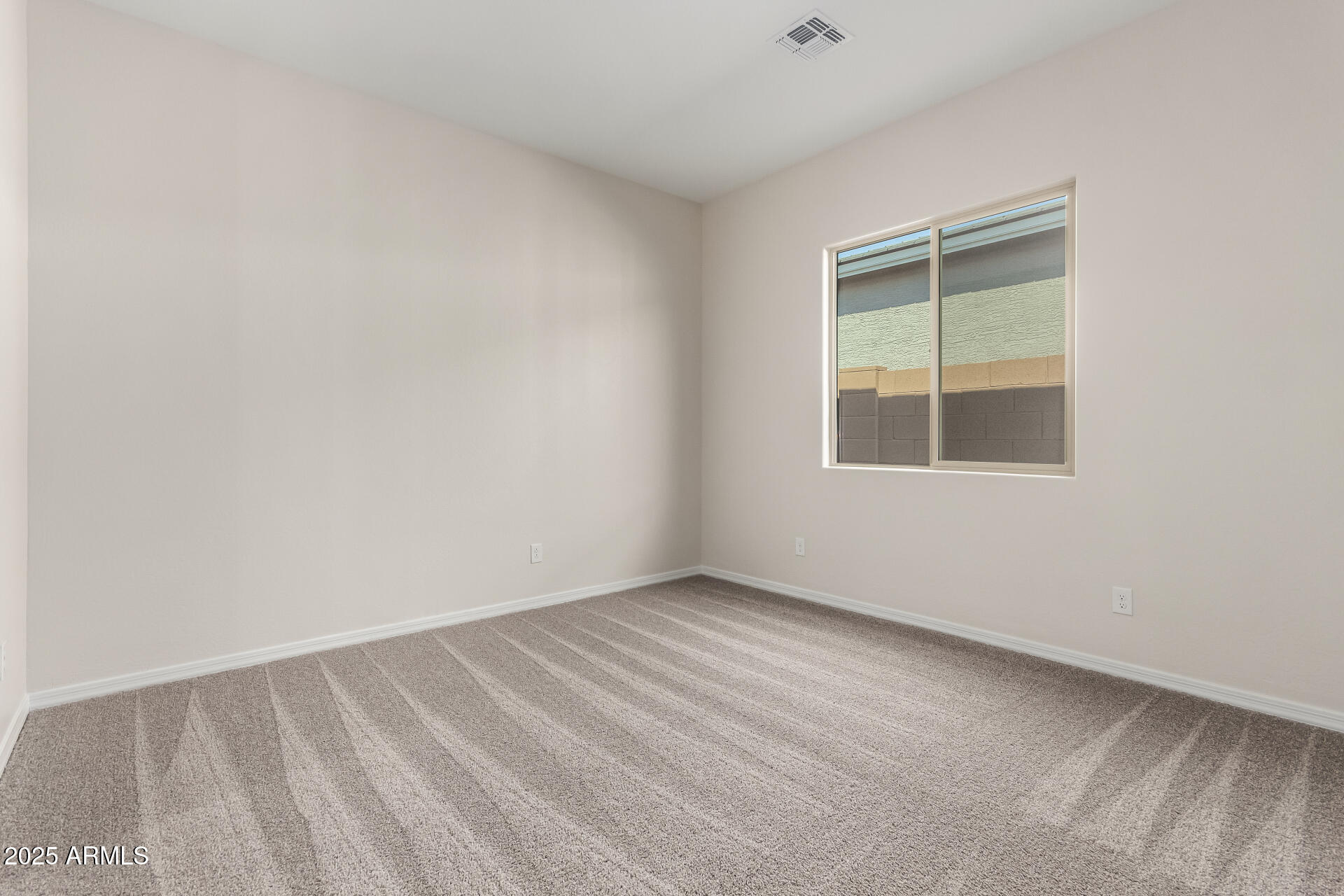 4818 West Capistrano Avenue Laveen, AZ 85339 - Photo 23 of 44 an empty room with a window