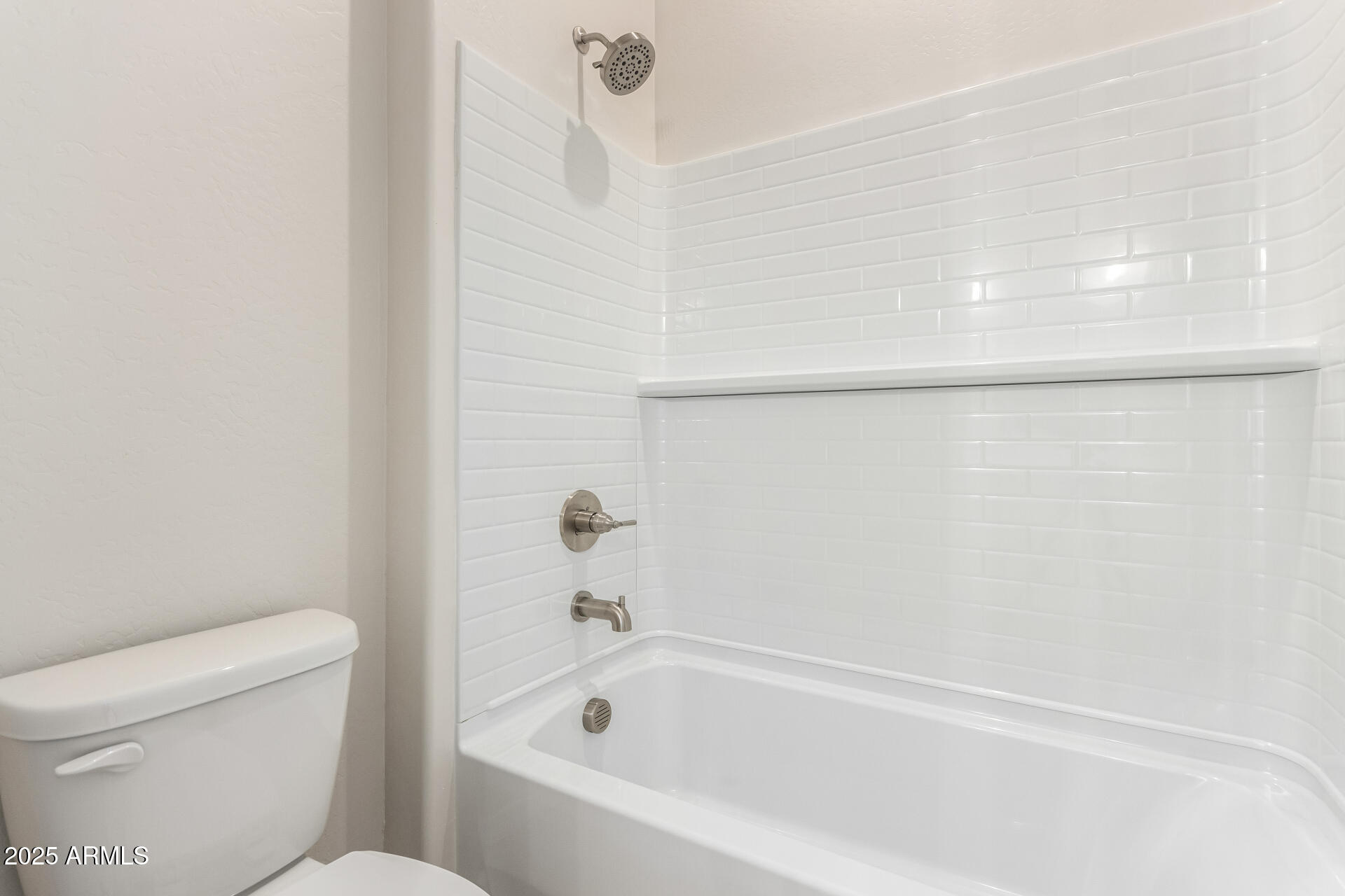 4818 West Capistrano Avenue Laveen, AZ 85339 - Photo 29 of 44 a bathroom with a bathtub and toilet