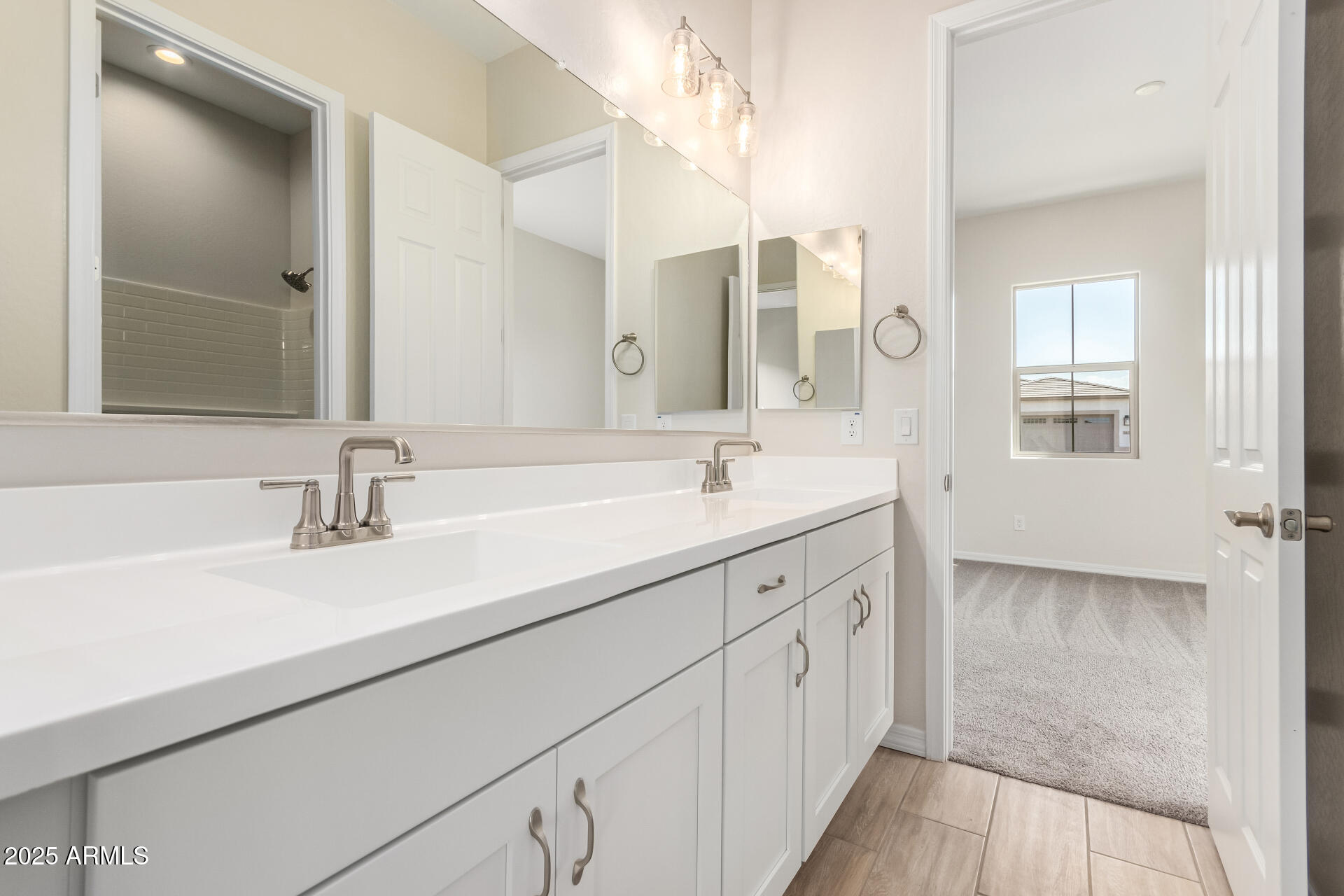 4818 West Capistrano Avenue Laveen, AZ 85339 - Photo 30 of 44 a spacious bathroom with a double vanity sink and mirror