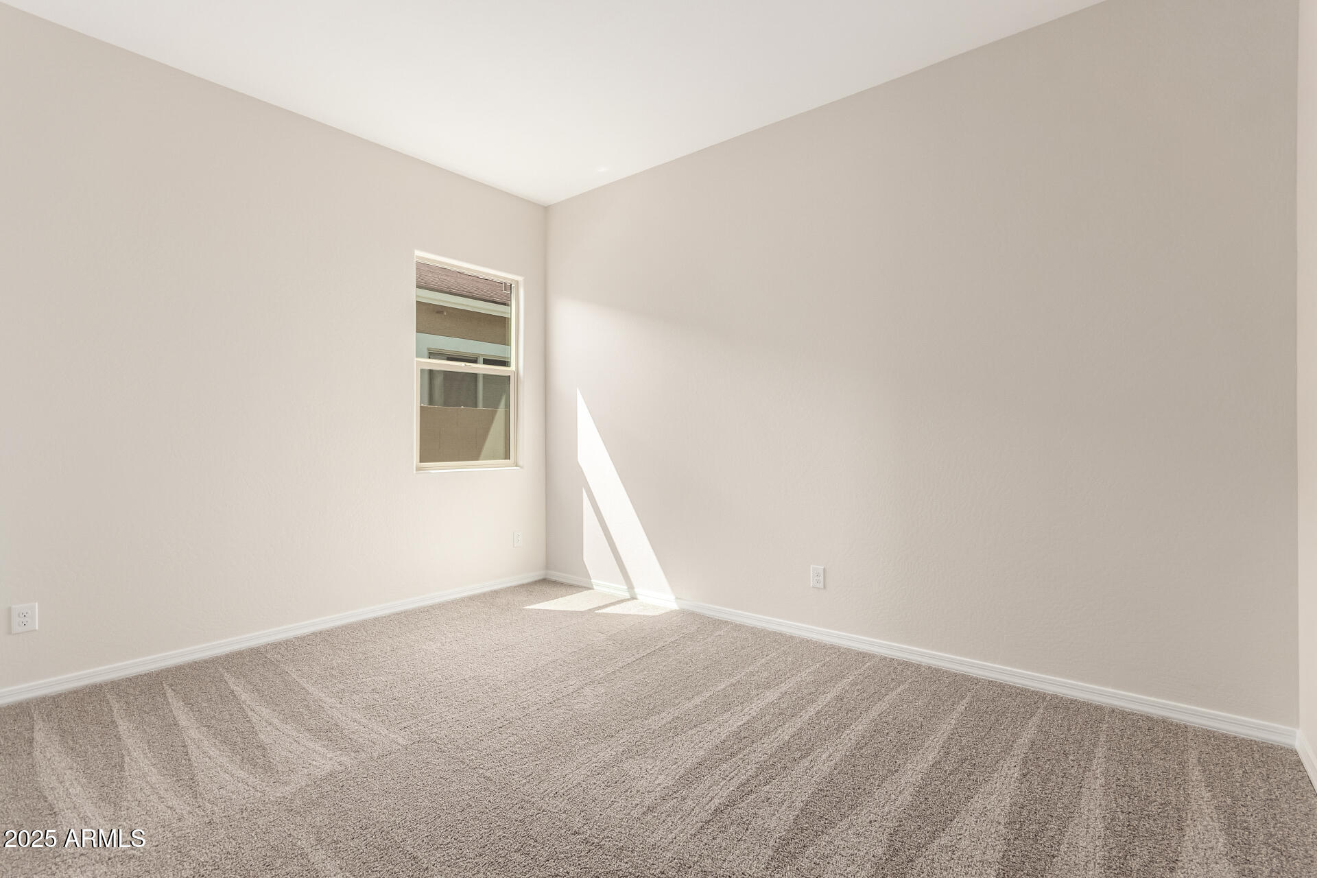 4818 West Capistrano Avenue Laveen, AZ 85339 - Photo 31 of 44 a view of an empty room with wooden floor and a window