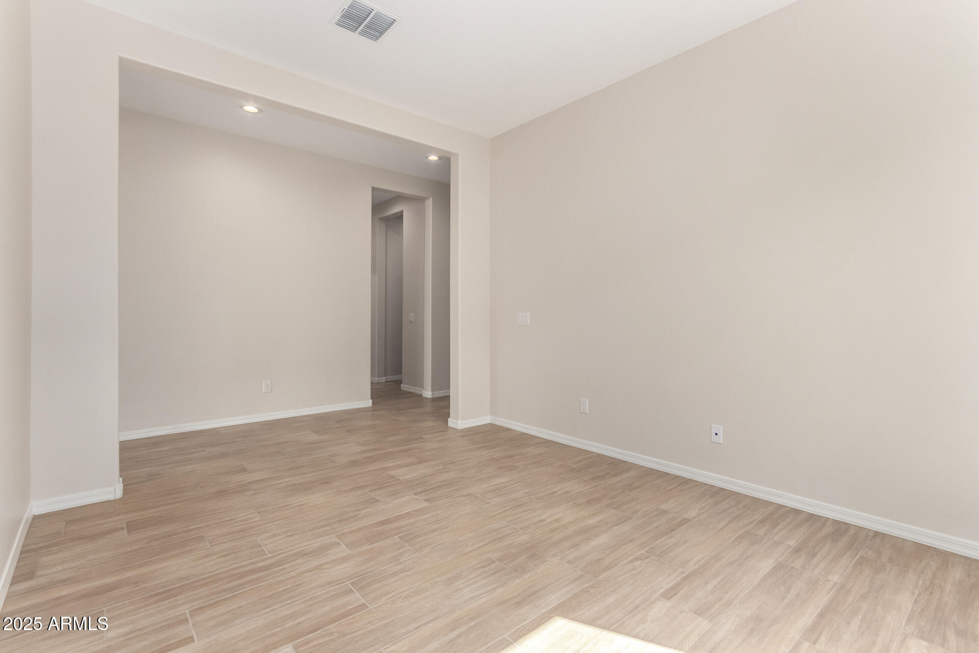 4818 West Capistrano Avenue Laveen, AZ 85339 - Photo 34 of 44 a view of an empty room with wooden floor