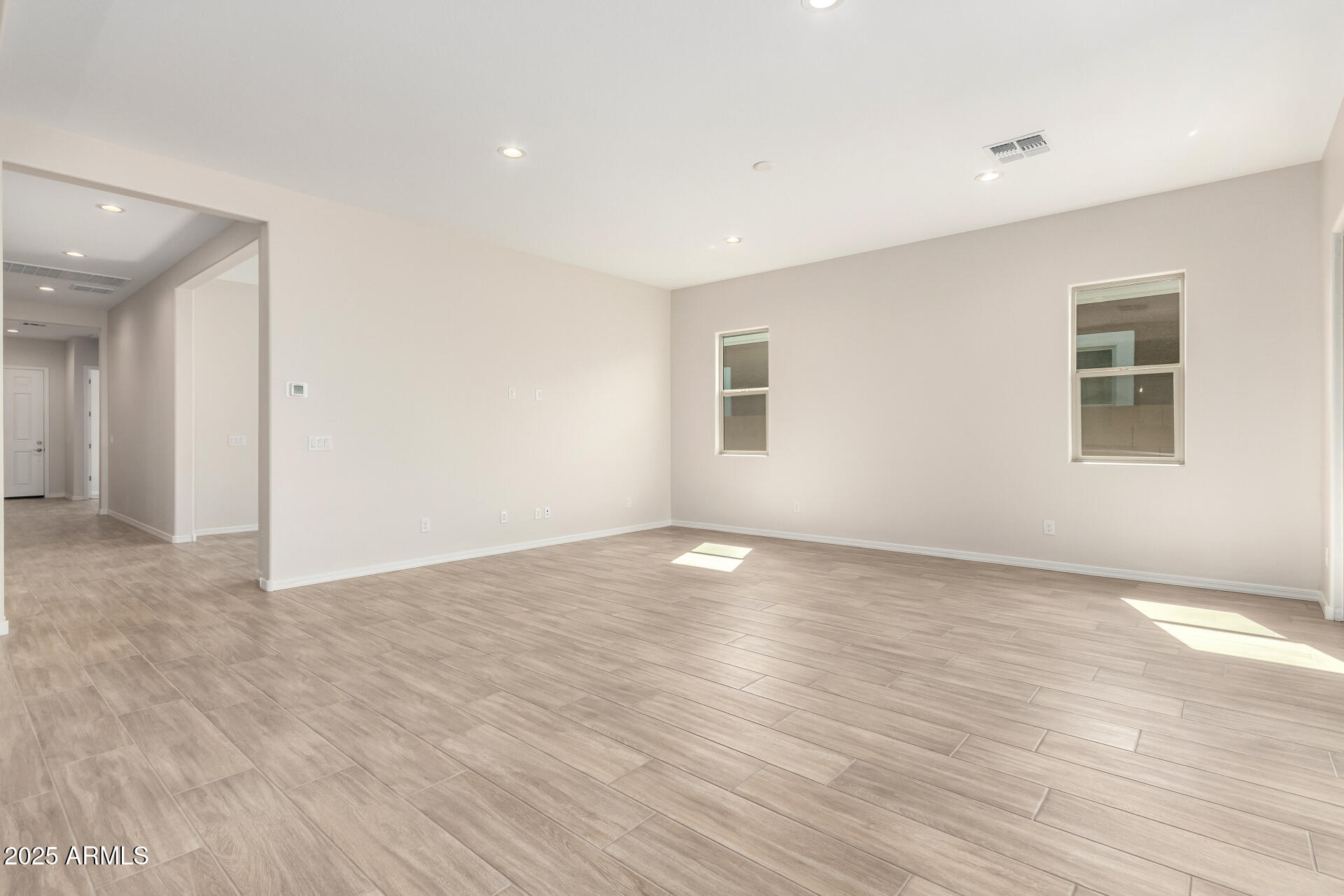 4818 West Capistrano Avenue Laveen, AZ 85339 - Photo 5 of 44 a view of an empty room with wooden floor and a window