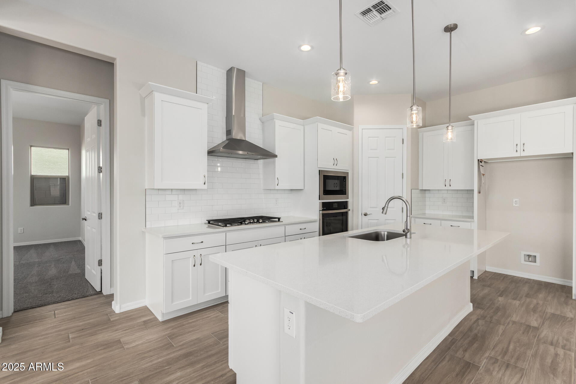 4818 West Capistrano Avenue Laveen, AZ 85339 - Photo 6 of 44 a kitchen with stainless steel appliances granite countertop a sink a stove a refrigerator and white cabinets