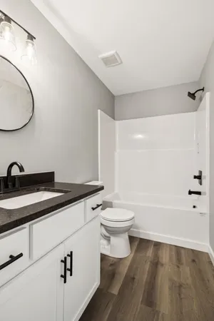 a bathroom with a sink a toilet and a mirror