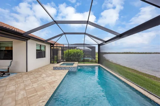a kitchen with stainless steel appliances a refrigerator stove microwave and white cabinets