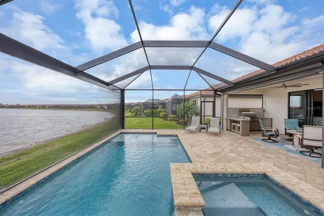 a kitchen with stainless steel appliances kitchen island granite countertop a sink stove and refrigerator