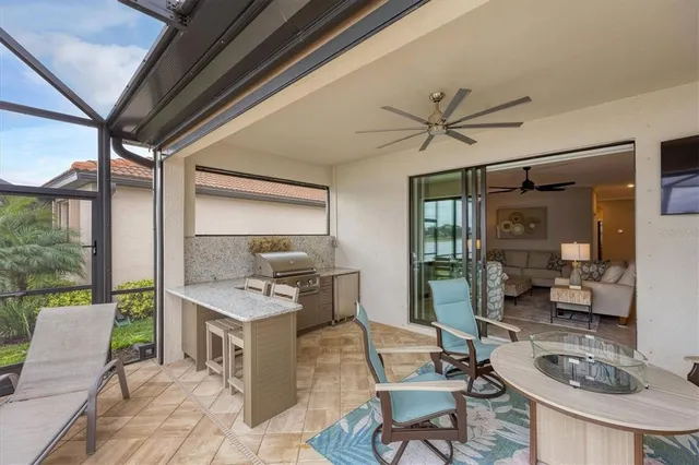 a kitchen with stainless steel appliances granite countertop a stove a sink a dining table and chairs