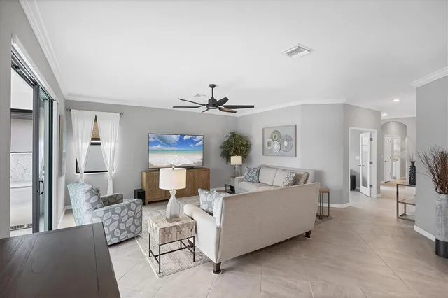 a large kitchen with stainless steel appliances a stove a sink dishwasher a dining table and chairs with wooden floor