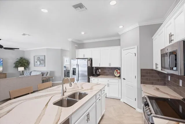 a bedroom with a bed a chandelier and a closet