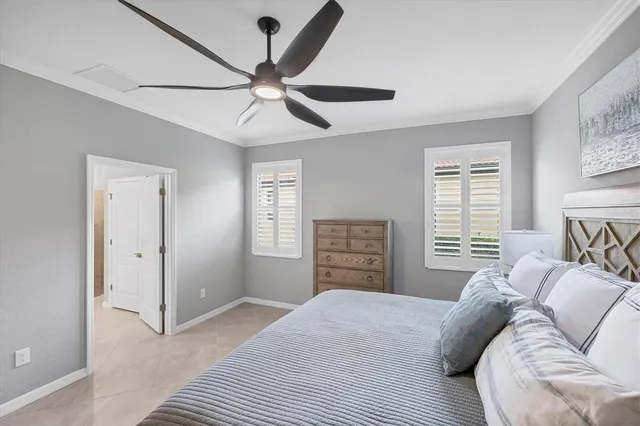 a room with lots of tables a large window and chairs