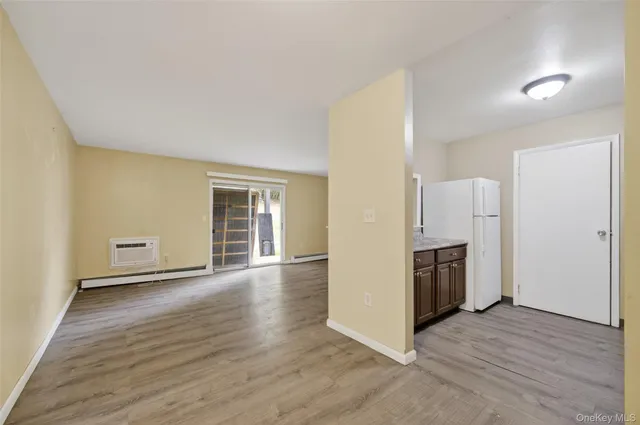 a view of a kitchen with refrigerator stove and wooden floor