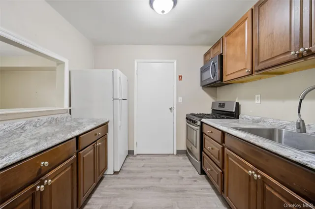 a kitchen with stainless steel appliances granite countertop a sink stove and cabinets