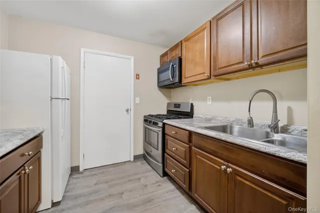 a kitchen with a stove and a refrigerator