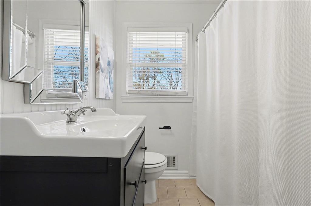 490 East Pharr Road Decatur, GA 30030 - Photo 21 of 33 a bathroom with a sink a toilet and a mirror