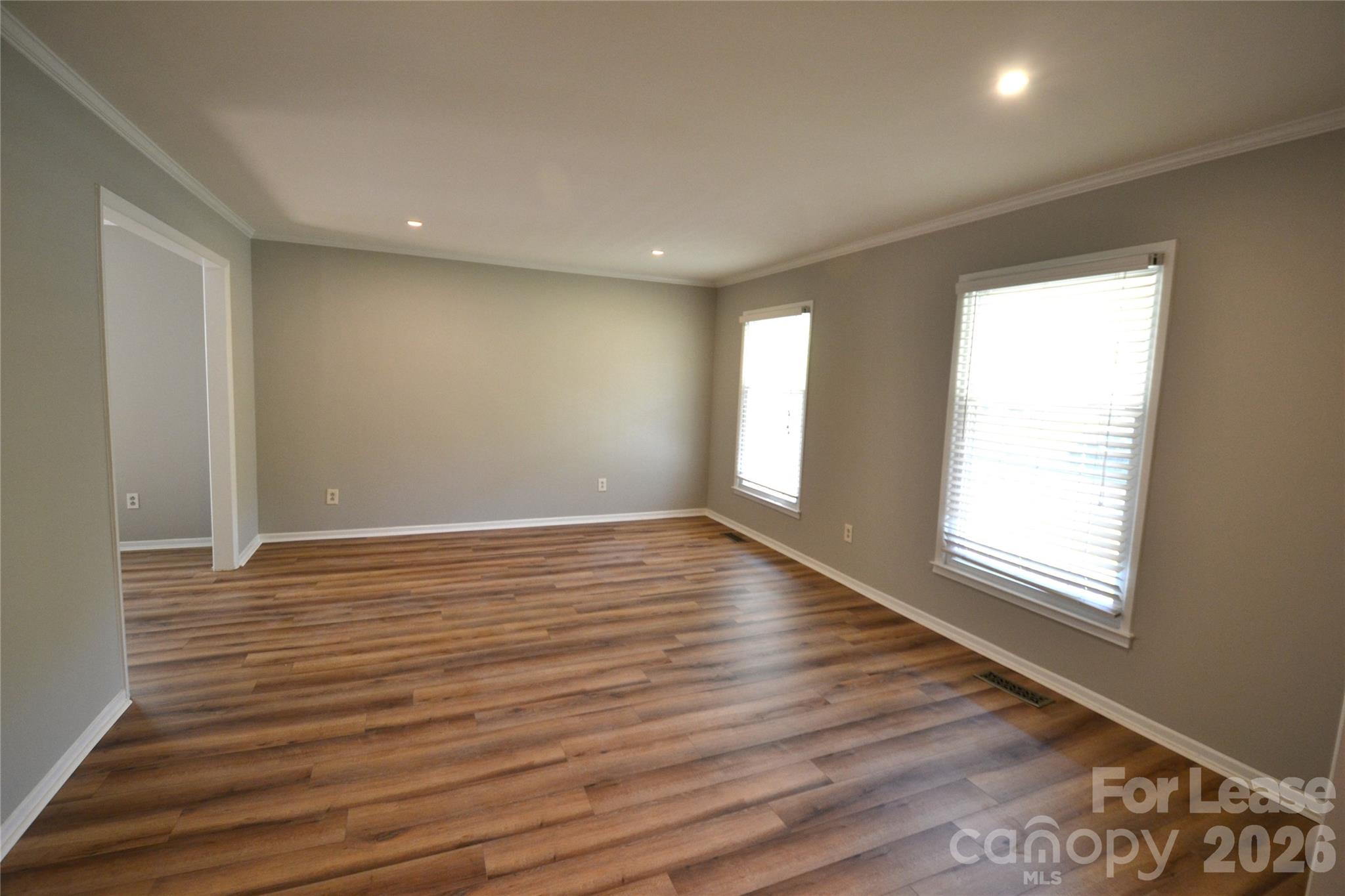 1422 Thermal Road Charlotte, NC 28212 - Photo 2 of 40 a view of an empty room with wooden floor and a window