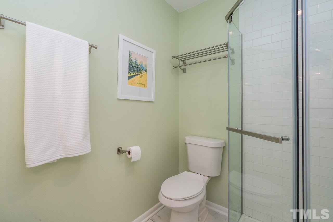 1012 Belfast Drive Raleigh, NC 27610 - Photo 22 of 30 a white toilet sitting next to a bathroom sink