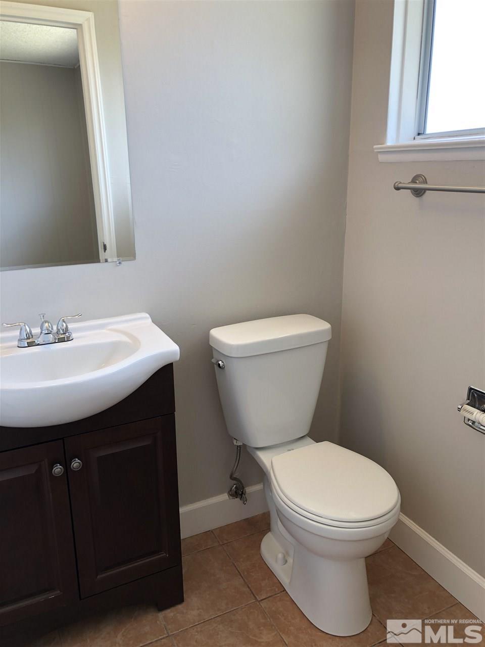 1995 Arcane Avenue Reno, NV 89503 - Photo 7 of 9 a bathroom with a toilet sink and mirror