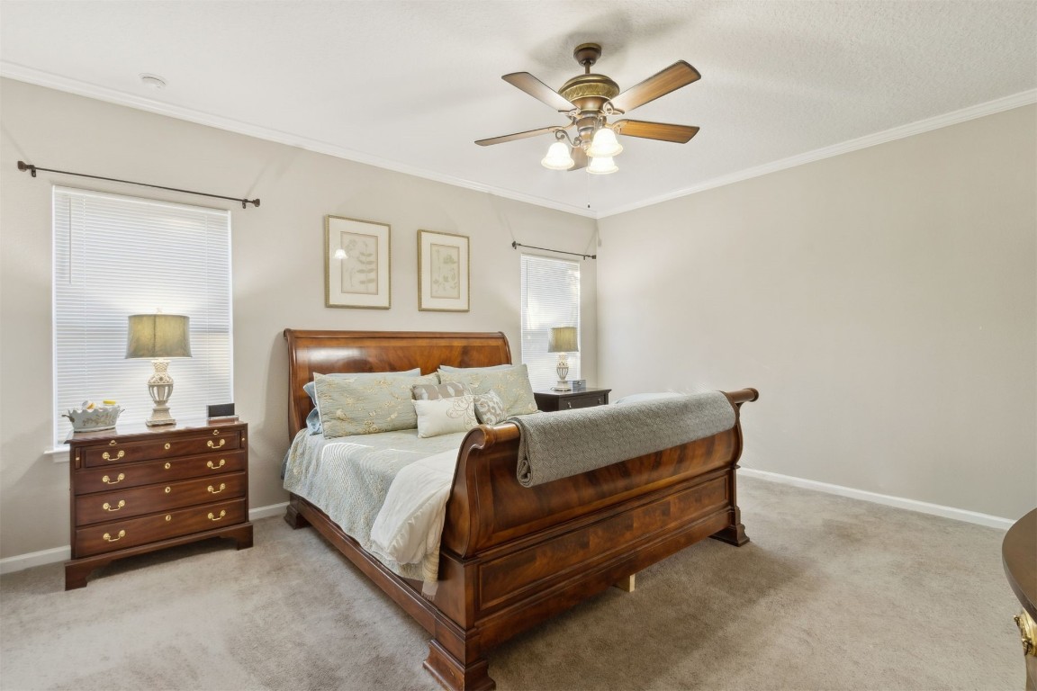 95275 Poplar Way Fernandina Beach, FL 32034 - Photo 13 of 38 a bedroom with a bed and a chandelier