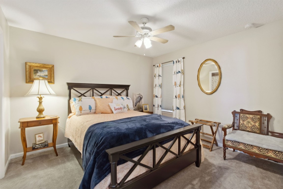 95275 Poplar Way Fernandina Beach, FL 32034 - Photo 19 of 38 a bedroom with a bed and a chandelier