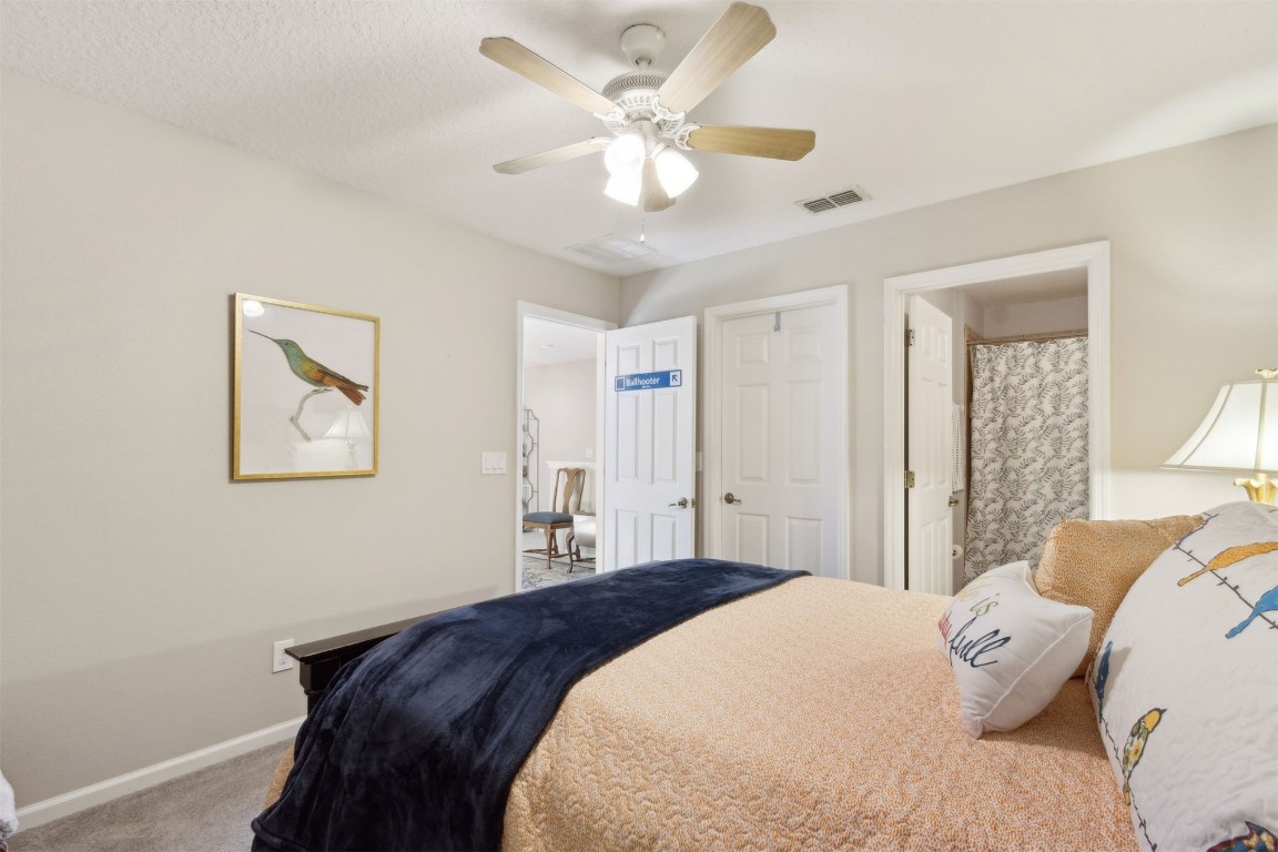 95275 Poplar Way Fernandina Beach, FL 32034 - Photo 20 of 38 a bedroom with a large bed and a ceiling fan