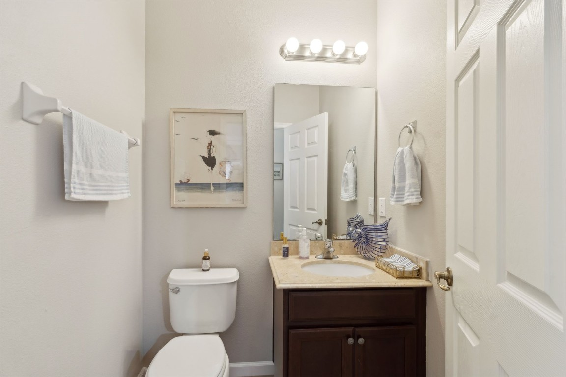 95275 Poplar Way Fernandina Beach, FL 32034 - Photo 25 of 38 a bathroom with a toilet sink and mirror