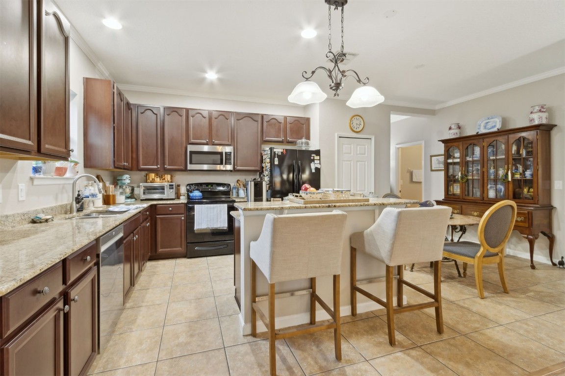 95275 Poplar Way Fernandina Beach, FL 32034 - Photo 4 of 38 a large kitchen with a table chairs and a refrigerator