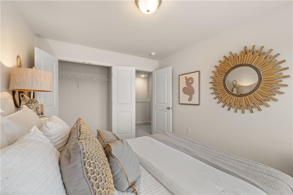 1035 Merritt Drive, Unit 94 Villa Rica, GA 30180 - Photo 18 of 49 a bedroom with a bed and a chandelier