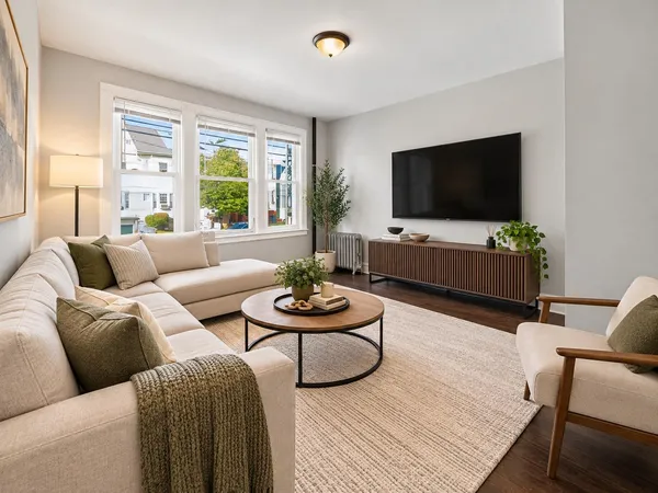 a living room with furniture and a flat screen tv