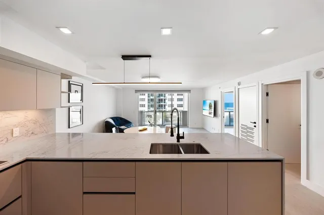 a kitchen with counter top space and windows