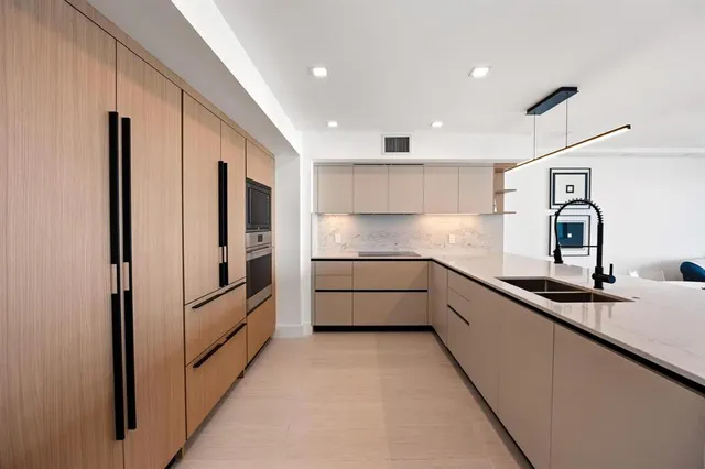 a kitchen with stainless steel appliances granite countertop a sink and cabinets
