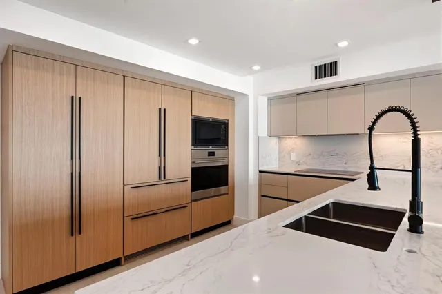 a kitchen with stainless steel appliances a refrigerator and a stove