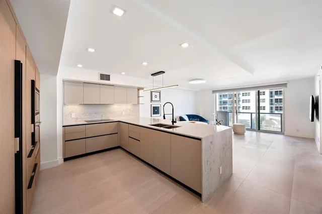 a kitchen with stainless steel appliances granite countertop a refrigerator and a sink