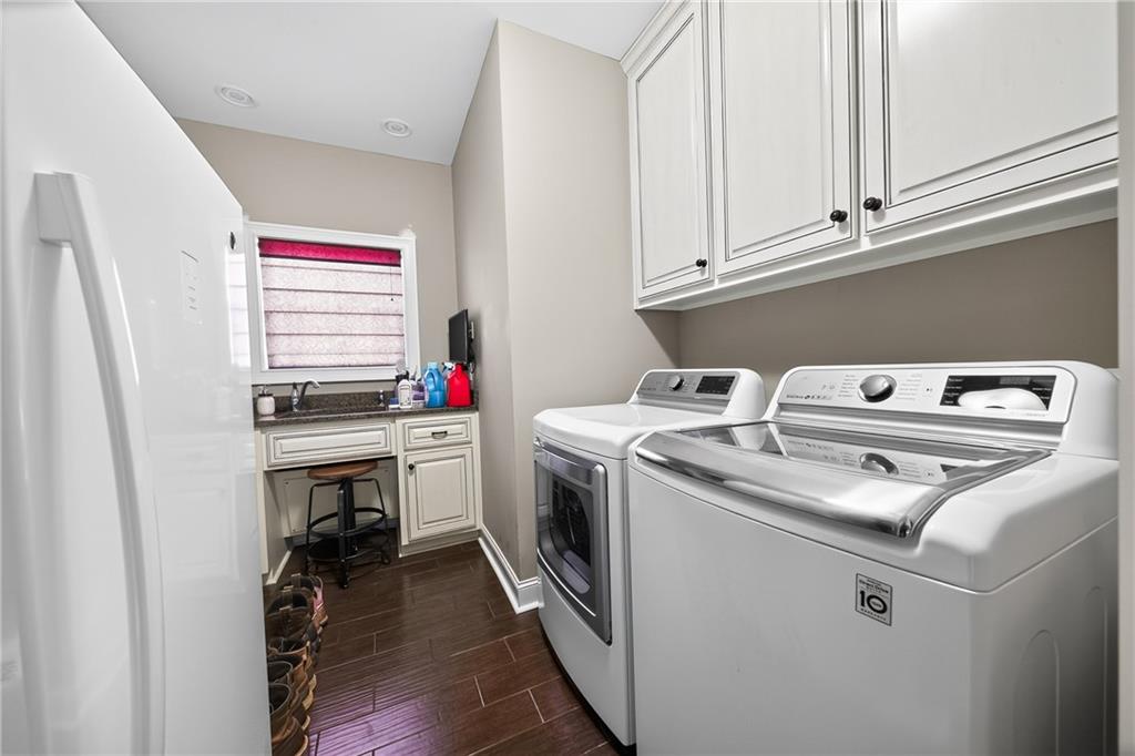 611 Padgetts Road Opelika, AL 36804 - Photo 21 of 64 Laundry area with wood-finish flooring, white cabinetry, recessed lighting, and a built-in sink with a countertop