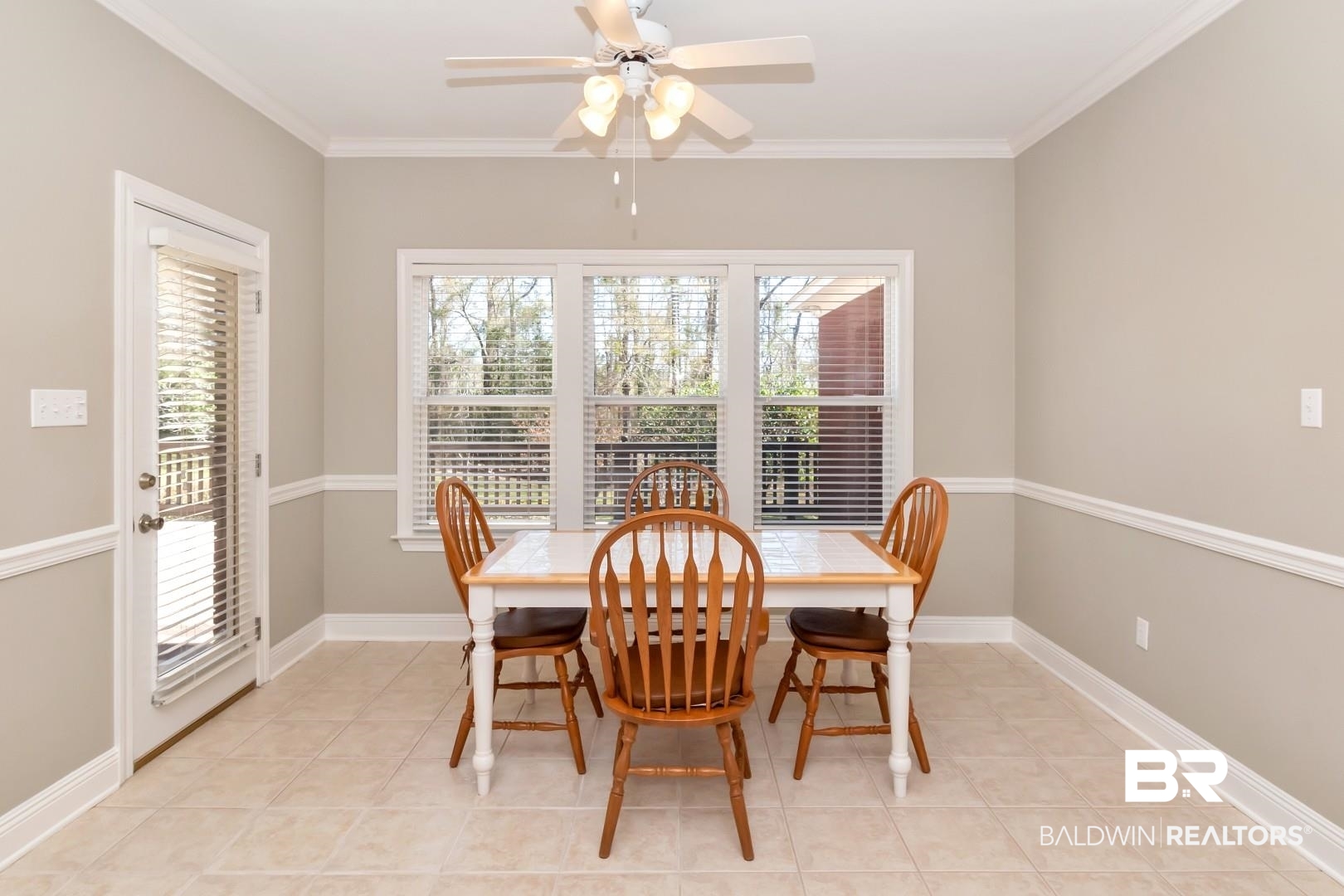 6090 Celeste Road Saraland, AL 36571 - Photo 15 of 38 Dining space featuring baseboards, light tile patterned floors, ceiling fan, and crown molding