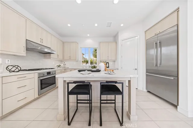 a kitchen with a sink stainless steel appliances and white cabinets