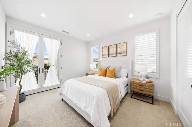 a bedroom with a bed and a potted plant