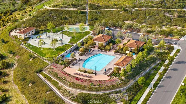a view of a swimming pool with lawn chairs under an umbrella