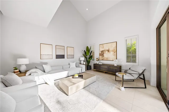 a living room with furniture large window and a table