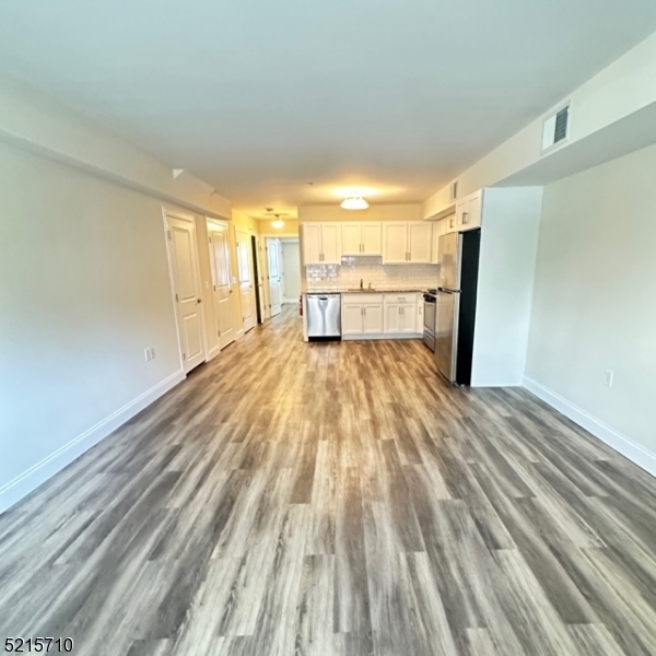 290 3rd Street, Unit D1 Hackensack, NJ 07601 - Photo 11 of 21 a view of a room with wooden floor