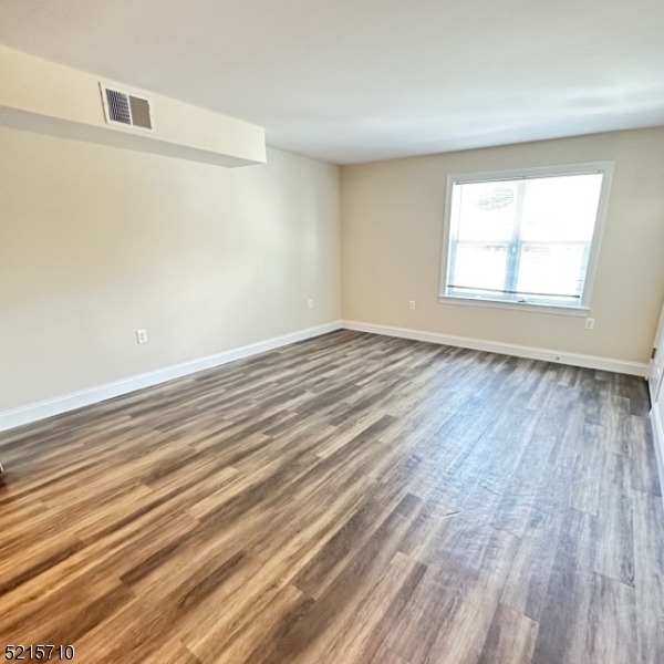 290 3rd Street, Unit D1 Hackensack, NJ 07601 - Photo 12 of 21 wooden floor in an empty room with a window